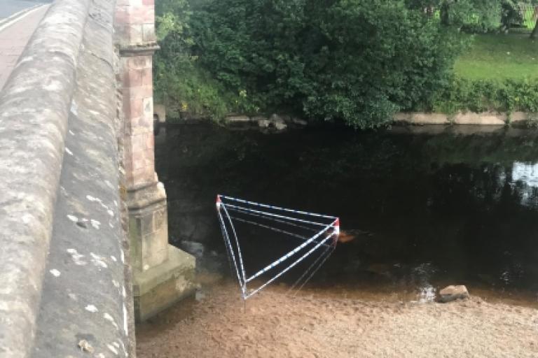 Tape marks area of River Eden at Appleby after an obstruction is found.