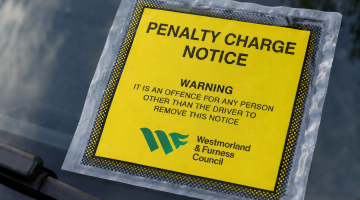 Penalty Charge Notice fixed to car windscreen